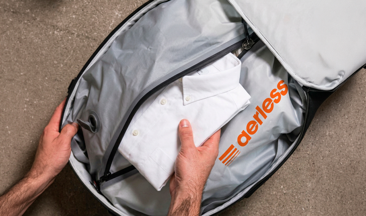 Placing a folded shirt into a suitcase with Aerless compression bag