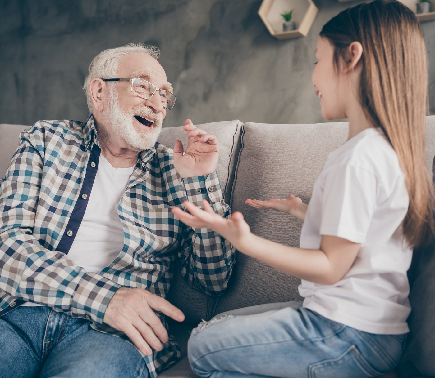 Person wearing Audien Atom 2 hearing aid in conversation