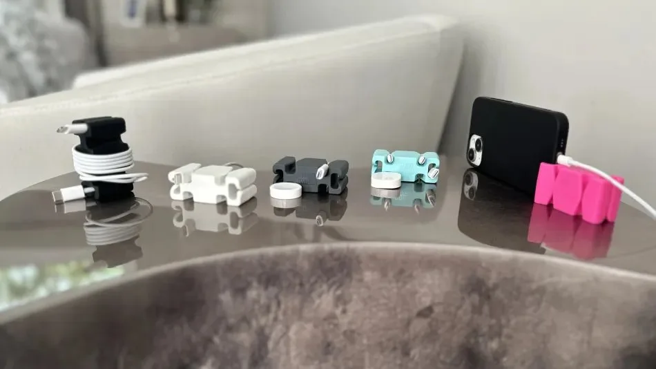 CordBrick organizers in multiple colors with cables and a phone