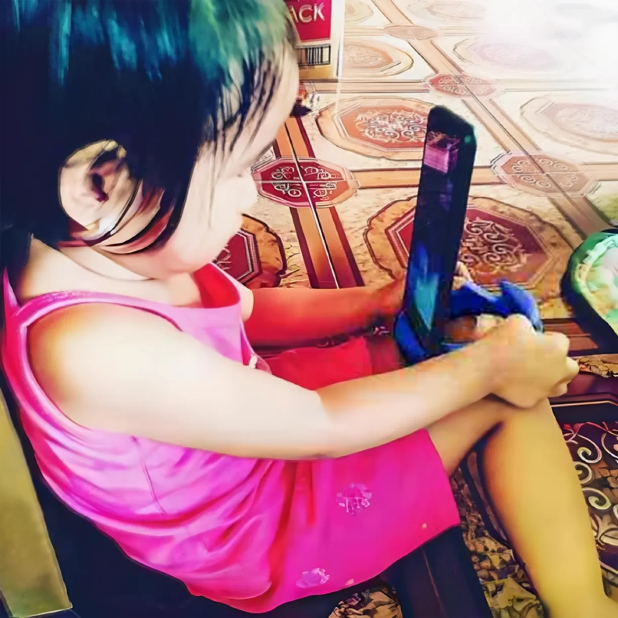 Child using GoDonut stand with a phone on the floor