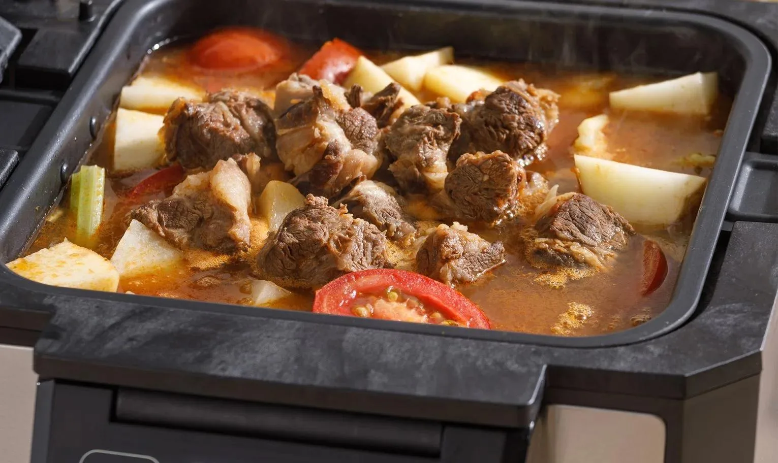 Stew with meat and vegetables cooking inside Gourmax Pro