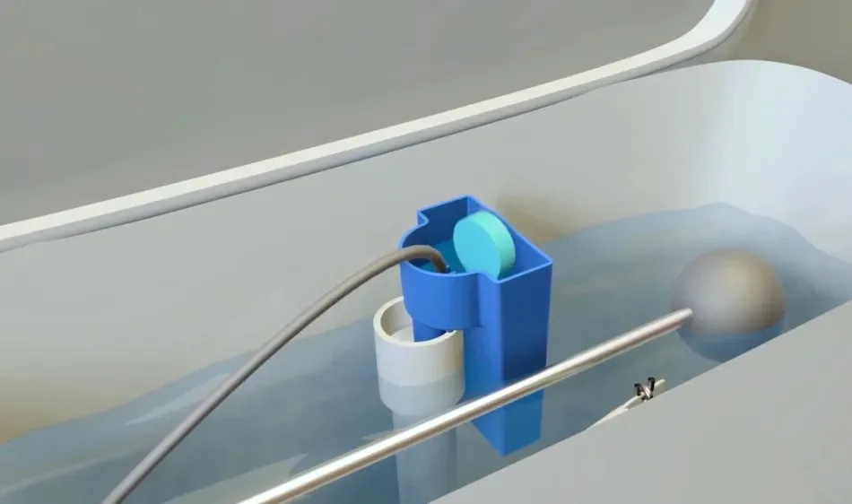 Box and blue toilet tank cleaner holder on closed toilet lid