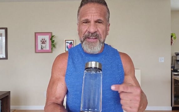 Woman drinking from the hydrogen water bottle outdoors