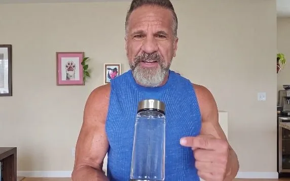 Woman drinking from the hydrogen water bottle outdoors
