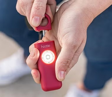 A red Hootie alarm with its strobe light actively lit