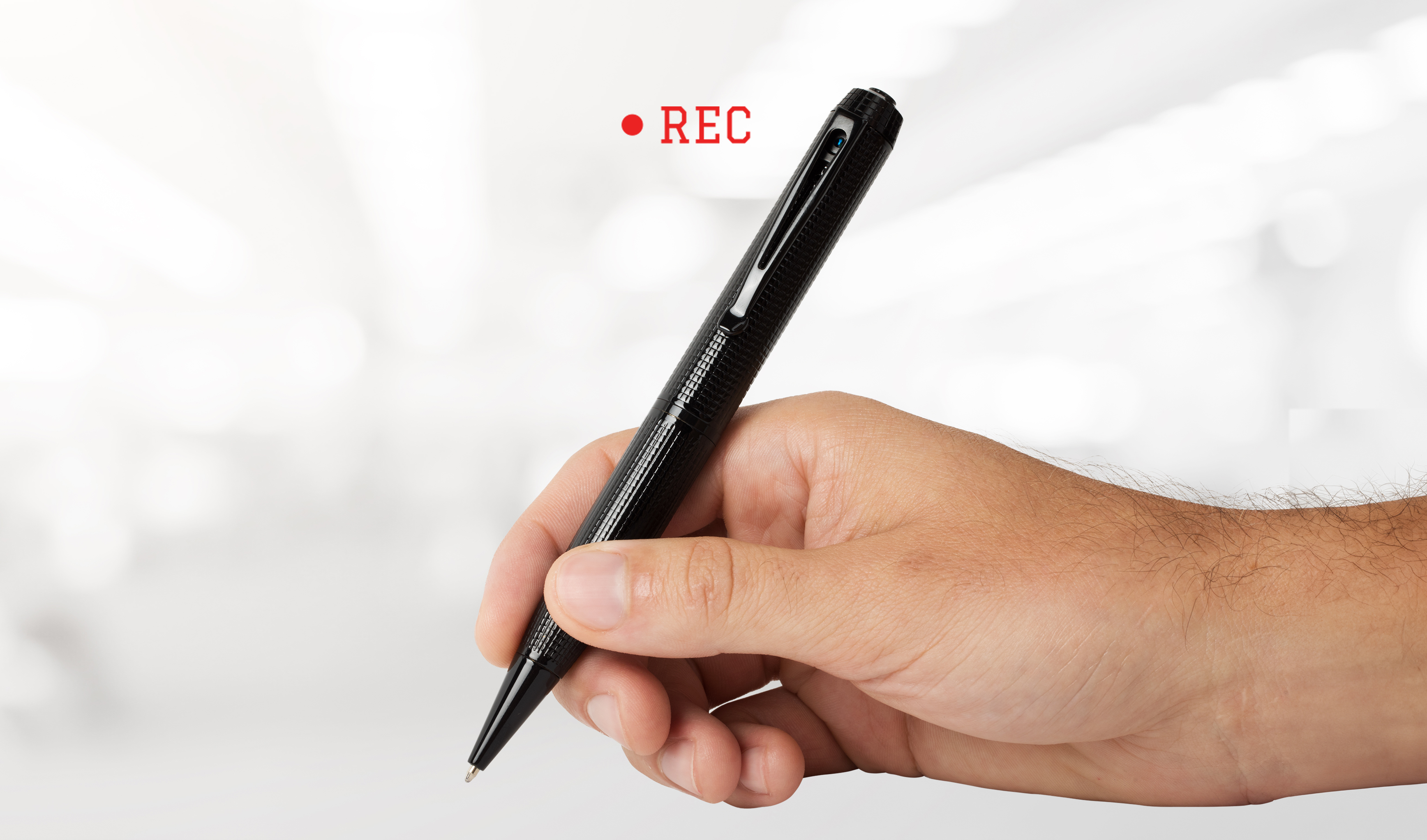 Hand holding iSpyPen Pro X with REC indicator
