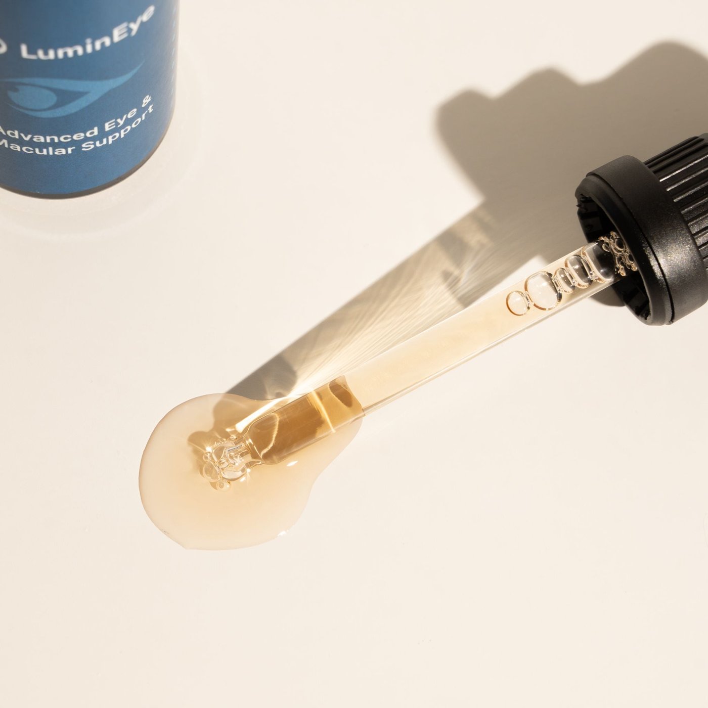 LuminEye bottle styled among flowers and a candle