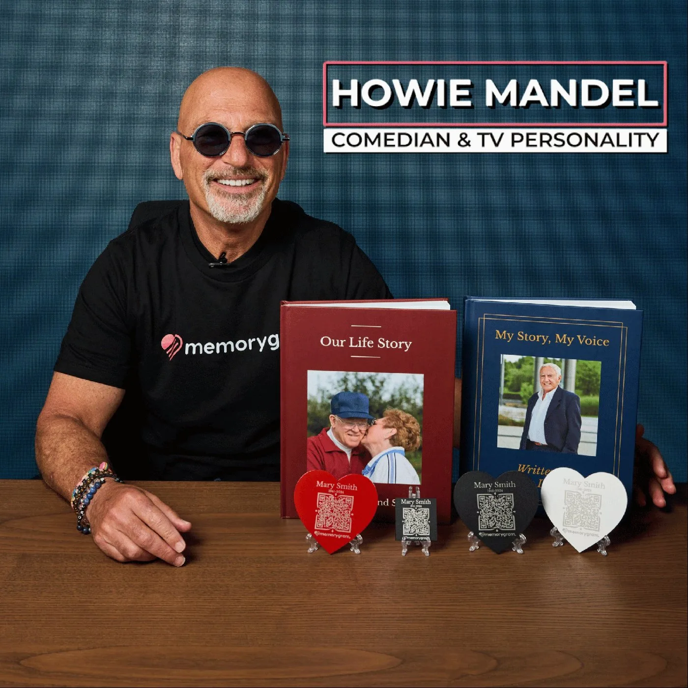 Howie Mandel holding two Memorygram Legacy Books alongside Memorygram medallions