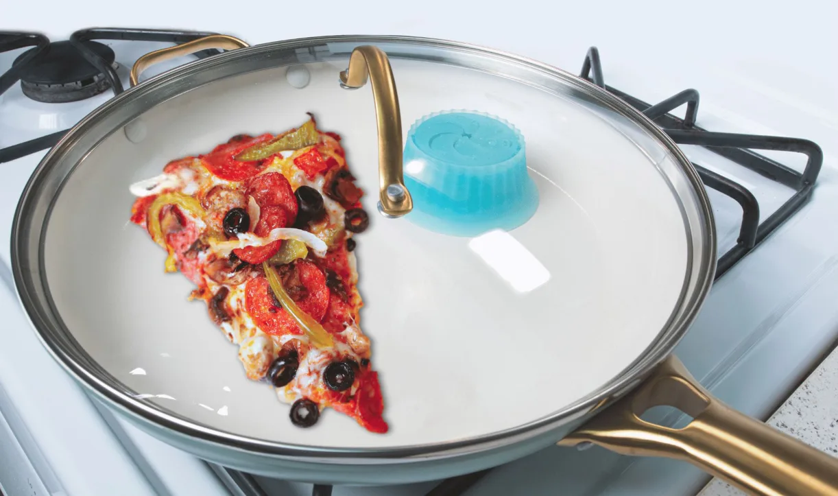 Pizza slice being reheated in a pan with Pacuzzi attached to the lid