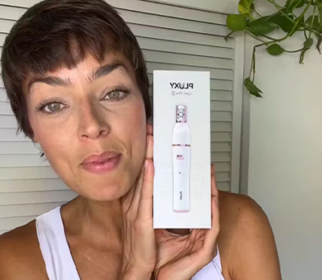 Customer holding Pluxy box and smiling