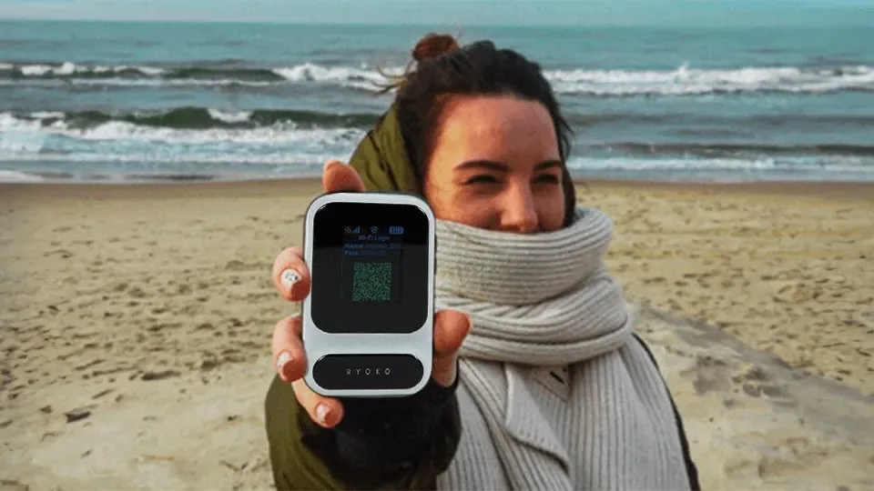 Person on a beach holding the Ryoko device up to the camera