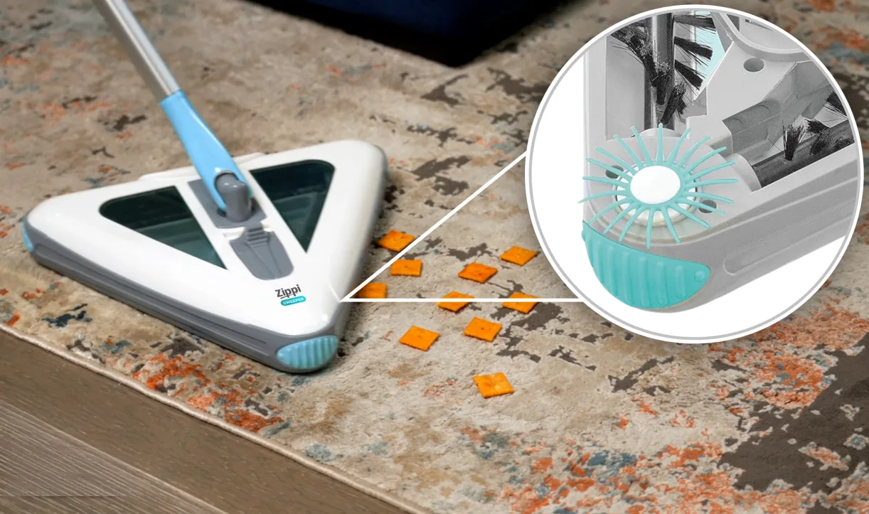 The sweeper picking up small debris with a close-up inset showing the brush detail