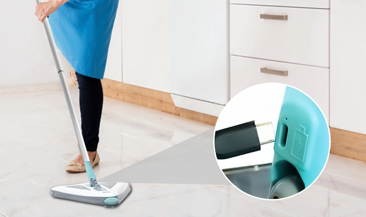 A person using the sweeper with an inset showing the USB charging port being plugged in