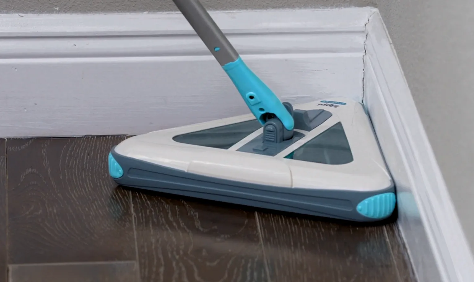 Zippi Sweeper cleaning in a tight corner on a hardwood floor